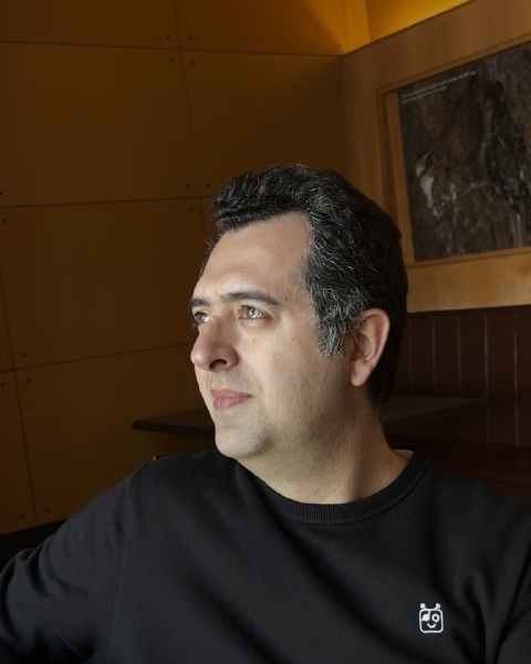 Sepehr Akhavan seated by a window